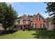 Charming brick home featuring a manicured lawn and traditional architectural details at 351 Prestbury Ct, Suwanee, GA 30024