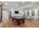 Well-lit game room includes a pool table, ping pong setup, and access to a full bathroom at 351 Prestbury Ct, Suwanee, GA 30024