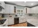 Beautiful kitchen featuring white cabinets, detailed backsplash, granite countertops, and stainless steel appliances at 351 Prestbury Ct, Suwanee, GA 30024