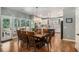 Bright and open kitchen connected to the breakfast area with hardwood floors and white cabinetry at 351 Prestbury Ct, Suwanee, GA 30024