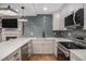 Modern kitchen boasts stainless steel appliances, sleek countertops, and stylish backsplash at 351 Prestbury Ct, Suwanee, GA 30024