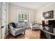 Comfortable living room showcasing neutral tones, natural light and hardwood floors at 351 Prestbury Ct, Suwanee, GA 30024
