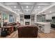 Inviting living room with fireplace, adjacent to a modern kitchen with an island and bar seating at 351 Prestbury Ct, Suwanee, GA 30024