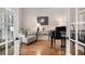 Cozy living room featuring hardwood floors, comfortable seating, and ample natural light at 351 Prestbury Ct, Suwanee, GA 30024