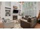 Bright living room with fireplace, built-in shelving, and large windows offering lots of natural light at 351 Prestbury Ct, Suwanee, GA 30024