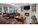 Cozy living room featuring a fireplace, built-in bookshelves, and a comfortable leather sofa at 351 Prestbury Ct, Suwanee, GA 30024