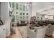 Spacious living room with tall windows, fireplace, and comfortable leather seating at 351 Prestbury Ct, Suwanee, GA 30024
