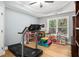 Bright playroom featuring a treadmill, storage and natural light, perfect for recreation at 351 Prestbury Ct, Suwanee, GA 30024