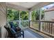Relaxing screened porch features wicker seating, outdoor rug, and a peaceful wooded view at 351 Prestbury Ct, Suwanee, GA 30024