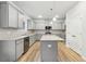 Spacious kitchen features grey cabinets, stainless appliances, an island, and granite countertops at 3623 Squires Park Ln, Loganville, GA 30052