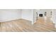 Open-concept living space featuring hardwood floors, staircase, and fireplace, with views into adjacent rooms at 3623 Squires Park Ln, Loganville, GA 30052