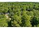 Aerial view of a neighborhood with tree coverage and houses nestled among the greenery at 6176 Hyde Park Ln, Lithonia, GA 30058
