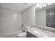 A well-lit bathroom showcases white marble subway tile, a granite vanity and a stylish square mirror at 6176 Hyde Park Ln, Lithonia, GA 30058