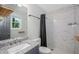 Modern bathroom featuring a granite vanity, marble tiled shower and brushed nickel fixtures at 6176 Hyde Park Ln, Lithonia, GA 30058