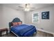 This simple bedroom features a ceiling fan, window and wood-look flooring at 6176 Hyde Park Ln, Lithonia, GA 30058