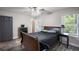 Cozy bedroom with gray walls, a ceiling fan, wood-look floors, windows and ample natural light at 6176 Hyde Park Ln, Lithonia, GA 30058
