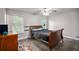 This light-filled bedroom features wood-look floors, a ceiling fan, two windows and warm wall color at 6176 Hyde Park Ln, Lithonia, GA 30058