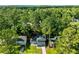 Charming home with a lush green lawn surrounded by tall trees, offering a serene and private setting at 6176 Hyde Park Ln, Lithonia, GA 30058