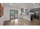 Modern eat-in kitchen with stainless steel appliances, gray cabinets, granite countertops, and stylish gray tile backsplash at 6176 Hyde Park Ln, Lithonia, GA 30058