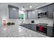 Modern kitchen boasts stainless steel appliances, gray cabinets, granite countertops, and a bright window at 6176 Hyde Park Ln, Lithonia, GA 30058