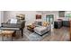 Open-concept living room features a piano, a grey couch, and an adjacent modern kitchen at 6176 Hyde Park Ln, Lithonia, GA 30058