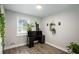 Bright home office featuring a window, stylish décor, and plants on a wood-look floor at 6176 Hyde Park Ln, Lithonia, GA 30058