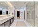 This primary bathroom features marble countertops, tile floors, and a spacious glass shower at 6399 Lucent Ln, Atlanta, GA 30328