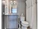 Bathroom with modern gray tiled wall, toilet, vanity and mirror, and shower with decorative curtain at 6399 Lucent Ln, Atlanta, GA 30328