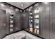 Walk-in closet with custom dark wood cabinetry, shelving, and a plush center ottoman at 6399 Lucent Ln, Atlanta, GA 30328