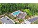 Aerial view of the community pool, clubhouse and parking lot amid lush green trees at 6399 Lucent Ln, Atlanta, GA 30328