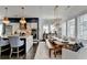 Stylish dining area featuring a long wooden table, comfortable seating, and bright natural light at 6399 Lucent Ln, Atlanta, GA 30328