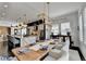 Open concept dining area with a farmhouse table, designer lighting, and kitchen island views at 6399 Lucent Ln, Atlanta, GA 30328
