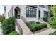 Close up of the exterior of this townhome featuring painted brick, a brick stairway, and black framed windows at 6399 Lucent Ln, Atlanta, GA 30328