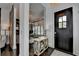 View of the foyer with dark wood floors, mirrored wall, stylish decor and a unique decorative barn door at 6399 Lucent Ln, Atlanta, GA 30328