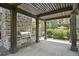 Community outdoor grill area features stone columns, a built in stainless steel grill, and shade at 6399 Lucent Ln, Atlanta, GA 30328