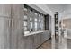Elegant built-in cabinets with glass fronts and counterspace, adjoining an open-concept living area at 6399 Lucent Ln, Atlanta, GA 30328