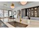 Modern kitchen island featuring a stainless steel sink, quartz countertop, and brass fixtures at 6399 Lucent Ln, Atlanta, GA 30328