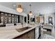 Spacious kitchen island features a sink and dishwasher, with an open layout, and seamlessly flowing into the living space at 6399 Lucent Ln, Atlanta, GA 30328
