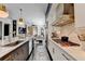 Modern kitchen with stainless steel appliances, marble countertops, and an open layout connecting to the living space at 6399 Lucent Ln, Atlanta, GA 30328