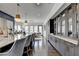 Well-designed kitchen boasts custom cabinets, sleek countertops, and an island with seating, seamlessly flowing into living area at 6399 Lucent Ln, Atlanta, GA 30328