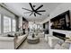 Spacious living room featuring marble fireplace, large ceiling fan, and open design to the kitchen at 6399 Lucent Ln, Atlanta, GA 30328