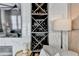Close up on the modern wine rack next to the fireplace in this comfortable living room at 6399 Lucent Ln, Atlanta, GA 30328
