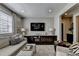Living room with comfortable seating, a large TV, stylish decor, and a convenient wet bar area at 6399 Lucent Ln, Atlanta, GA 30328