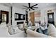 Open-concept living room features a modern fireplace, decorative furniture and large ceiling fan at 6399 Lucent Ln, Atlanta, GA 30328