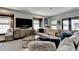 The living room features a large sectional couch, a big screen TV, and stylish decor for a comfortable living space at 6399 Lucent Ln, Atlanta, GA 30328