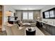 Modern living room with a comfortable sofa, stylish decor, and a convenient wet bar area at 6399 Lucent Ln, Atlanta, GA 30328