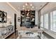 Well-appointed home office with custom built-ins, modern lighting, and a large window with shutters at 6399 Lucent Ln, Atlanta, GA 30328