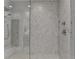 Glass enclosed shower stall featuring mosaic tile accents, a rainfall shower head, and a built in bench at 6399 Lucent Ln, Atlanta, GA 30328