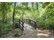 A serene wooden bridge on a shady, wooded walking trail at 6399 Lucent Ln, Atlanta, GA 30328