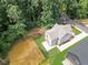 New construction home with gray siding, a concrete driveway, and a partially seeded, expansive backyard at 2214 Meador Ave Se, Atlanta, GA 30315